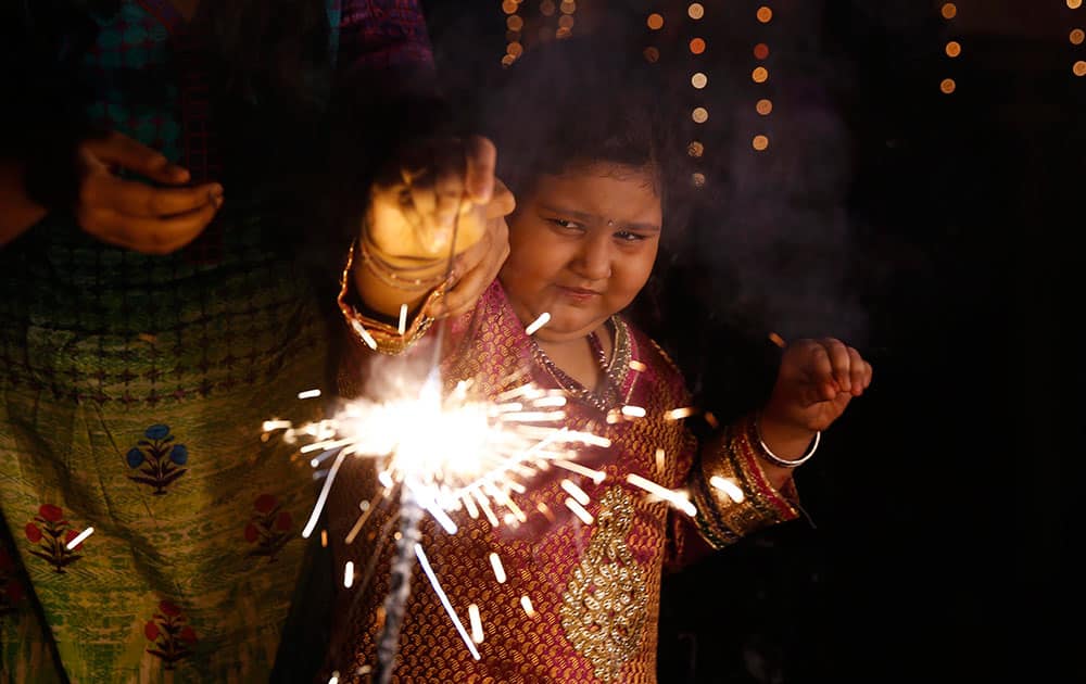 A child plays with firecrackers during Diwali celebrations in Allahabad, India.