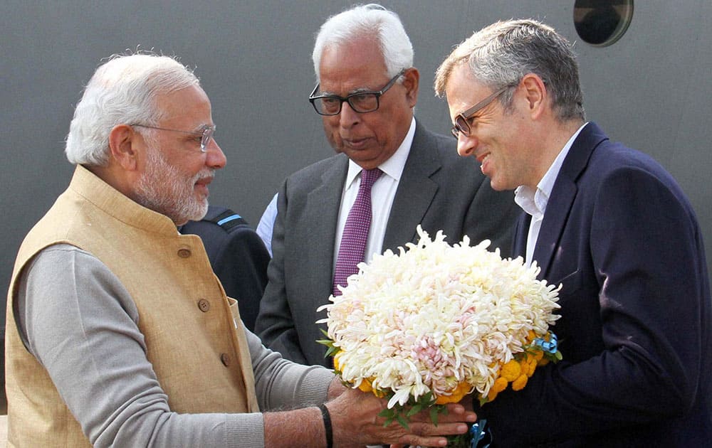 PRIME MINISTER, NARENDRA MODI BEING RECEIVED BY GOVERNOR N. N. VOHRA AND CHIEF MINISTER OMAR ABDULLAH AT AIRPORT IN SRINAGAR.