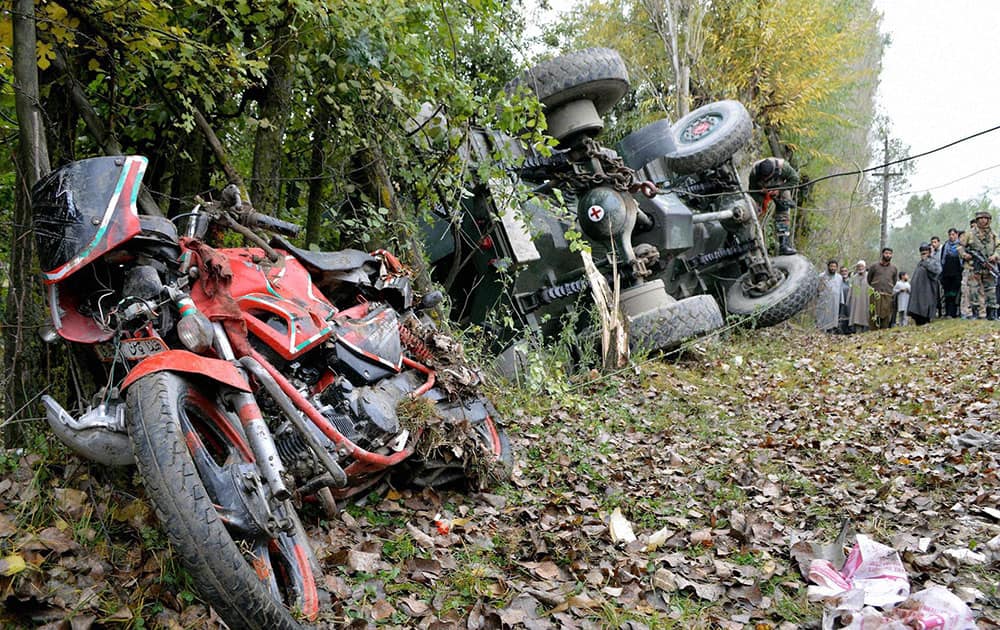 Army and Locals inspecting the damaged Army vehicle and a bike after an accident in which two Army Jawans and a civilian were injured,at Janbazpora in Baramulla District 55 kms from Srinagar.
