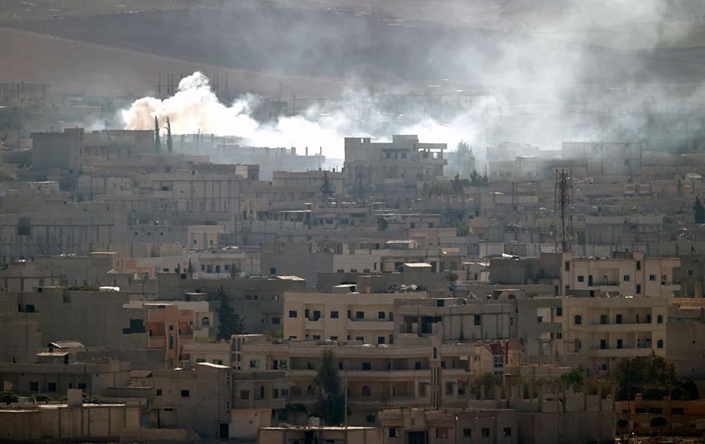 Smoke rises during fighting in Kobani, seen from a hilltop on the outskirts of Suruc, near the Turkey-Syria border.
