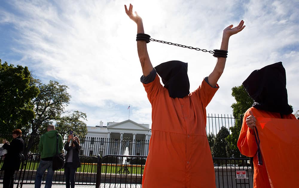 People protest against 'indefinite detentions' at Guantanamo Bay detention center and Bagram prison, while in front of the White House in Washington. 