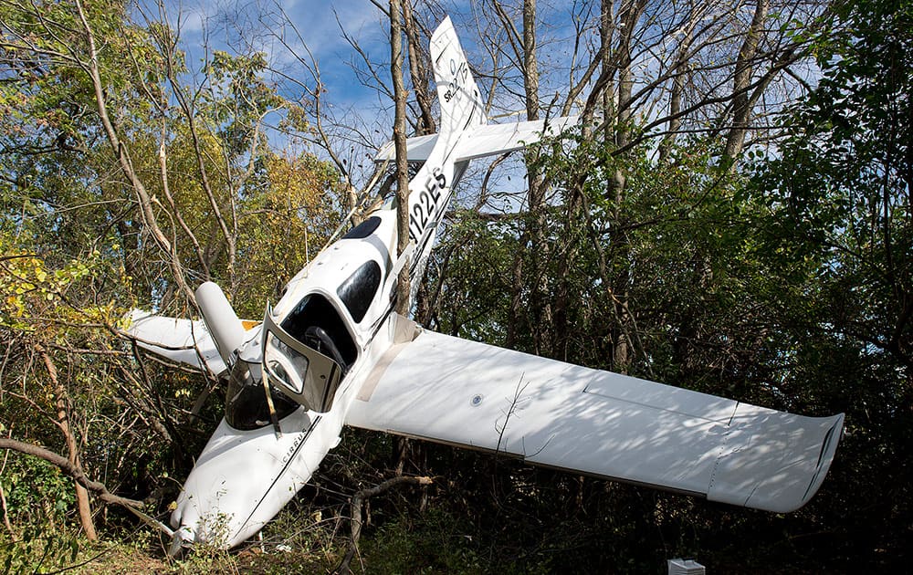 The Cirrus SR22 airplane rests in a tree in a wood line off Monocacy Blvd. following a midair collision with a helicopter.