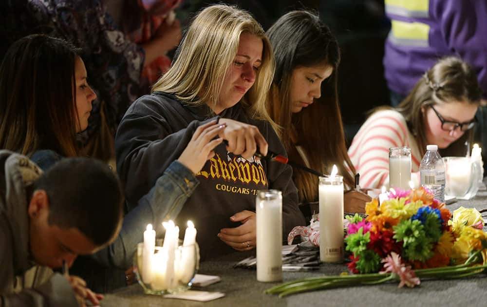 Young People light candles on the stage at the Grove Church in Marysville, Wash., after a memorial vigil held for people affected by a shooting at Marysville Pilchuck High School earlier in the day.