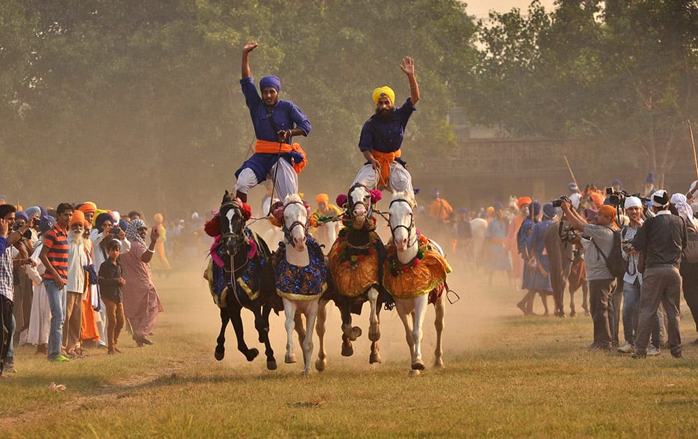 Sikh religious warriors, display their horse-riding skills at an event organized to celebrate 'Fateh Divas' in Amritsar.