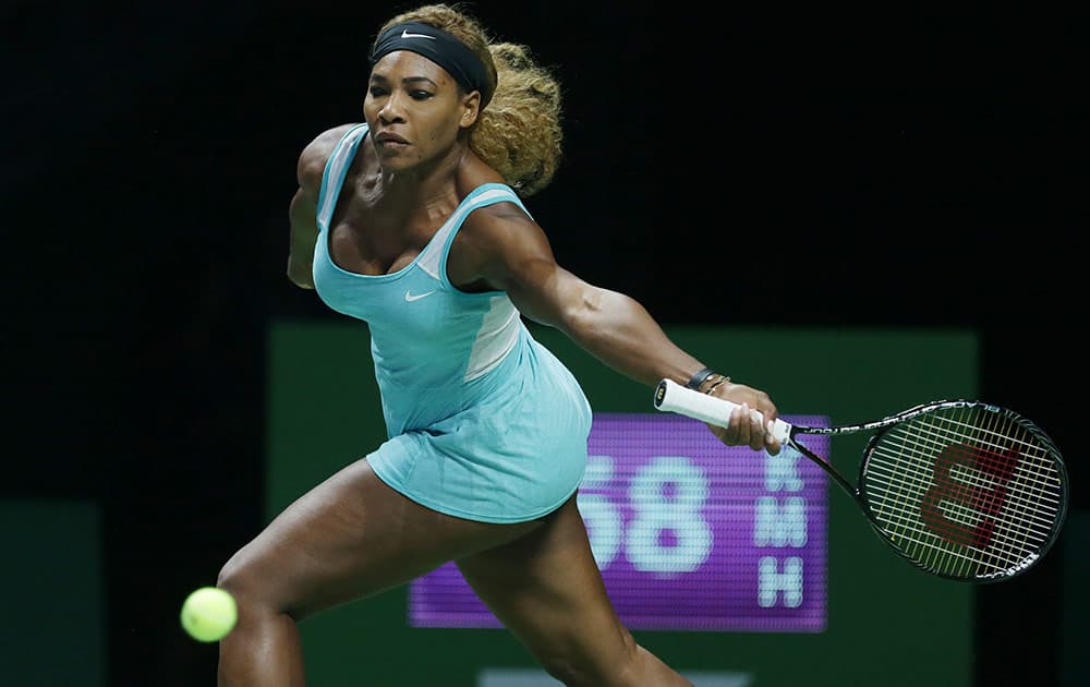 Serena Williams of the US reaches for a return to Denmark's Caroline Wozniacki during their semifinal match at the WTA tennis finals in Singapore.