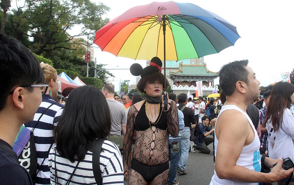 Participants revel through a street during gay and lesbian parade in Taipei, Taiwan.