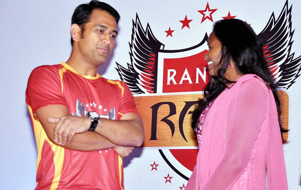 Indian Cricket team Captain and brand ambassador of new Hockey India league (HIL) team Ranchi Rays Mahendra Singh Dhoni talks to Hockey India player Ashunta Lakra during launch of hockey team in Ranchi.