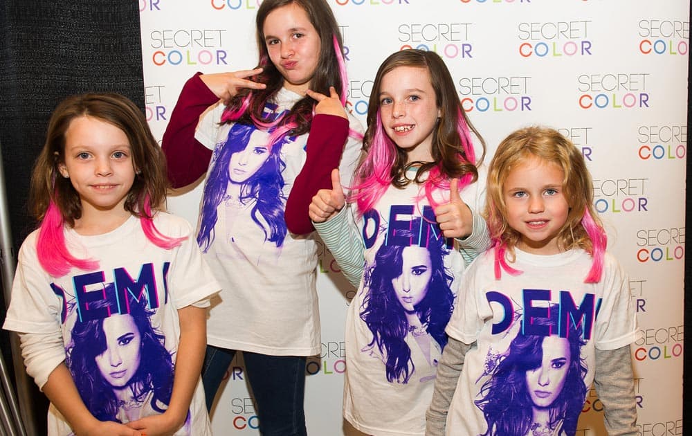 IMAGE DISTRIBUTED FOR SECRET COLOR - Demi Lovato fans pose with hair extensions they had added at the Secret Color Salon during the Demi Lovato World Tour in Newark, N.J.