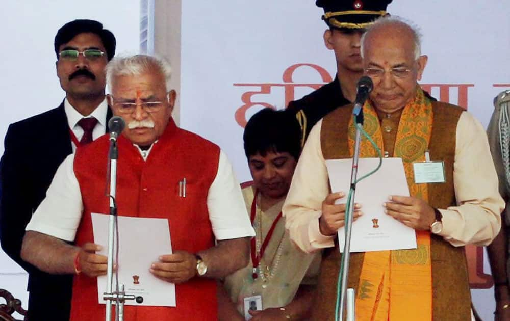 Haryana Governor Kaptan Singh Solanki administers oath to the new Chief Minister Manohar Lal Khattar at a function in Punchkula.