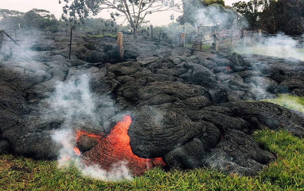 This Oct. 26, 2014 photo provided by the U.S. Geological Survey shows the lava flow front of from an eruption that began the June 27, as the front remains active and continues to advance towards the northeast threatening the town of Pahoa on the Big Island of Hawaii. 