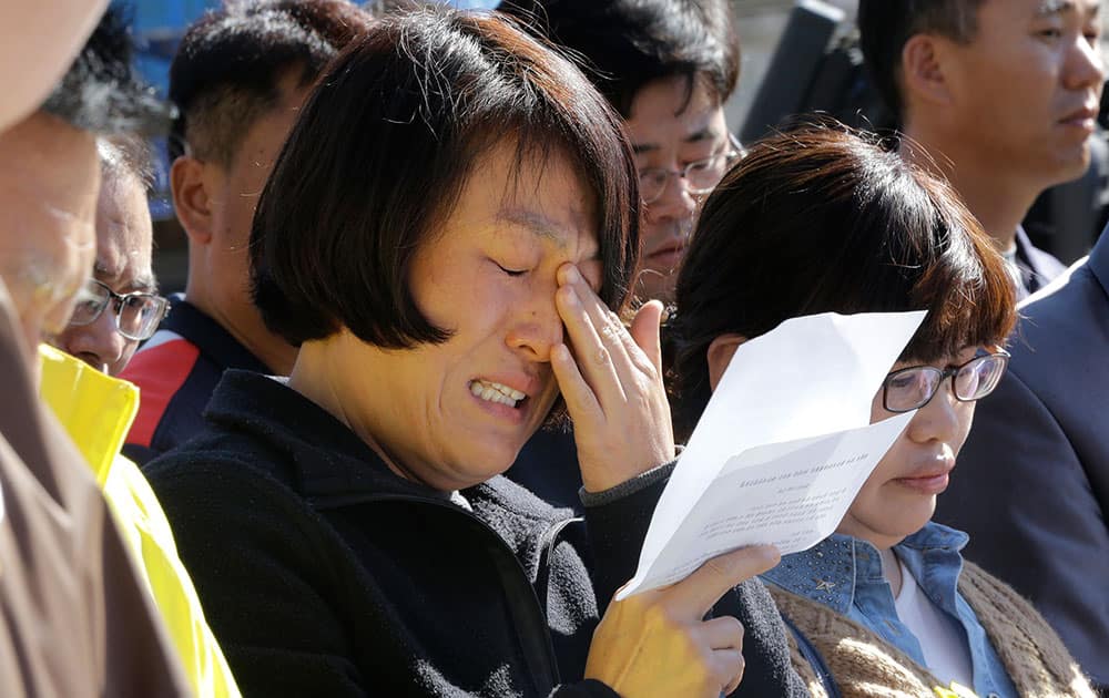 An unidentified family member of passengers aboard the sunken ferry Sewol caries as she demands maximum punishment to be sentenced on the crew members of the ferry during their trial at Gwangju District Court in Gwangju, South Korea.
