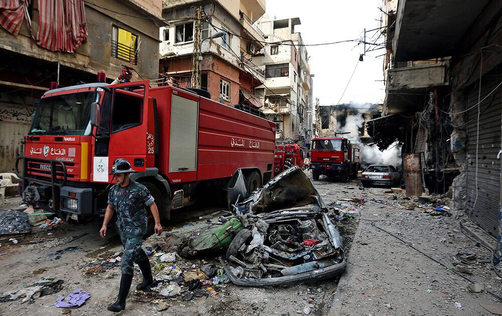 Lebanese firefighters extinguish burned shops damaged due to clashes between the Lebanese army and Islamic militants in the northern port city of Tripoli, Lebanon.