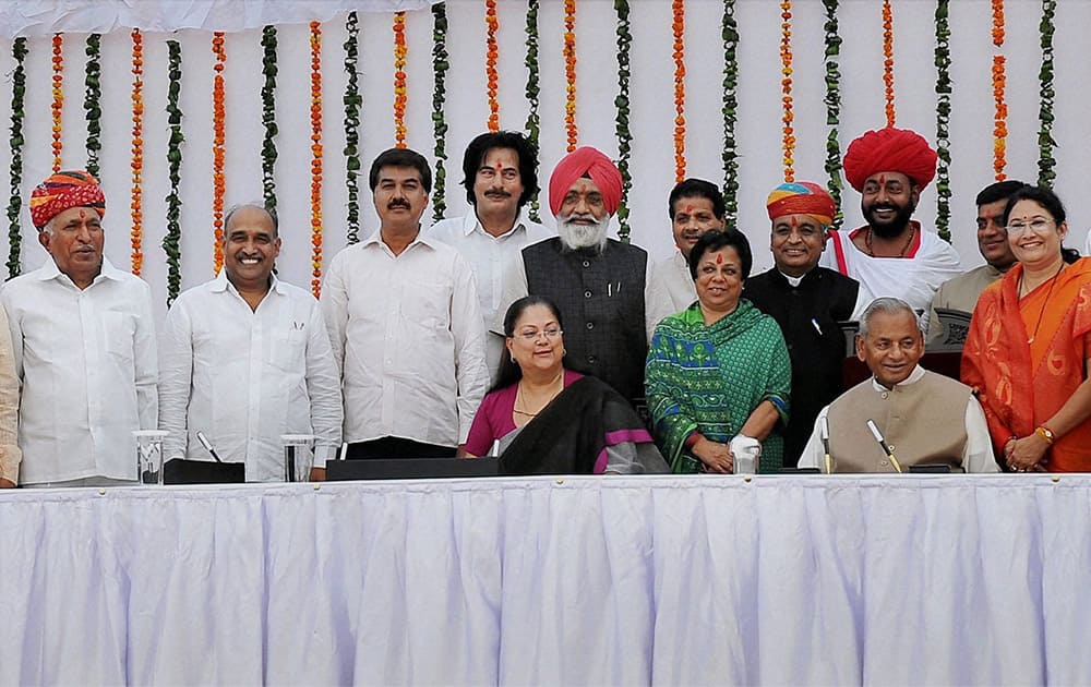 Rajasthan Governor Kalyan Singh and Chief Minister Vasundhara Raje pose for a group photo with newly sworn-in Cabinet Ministers at a ceremony at Raj Bhawan in Jaipur.