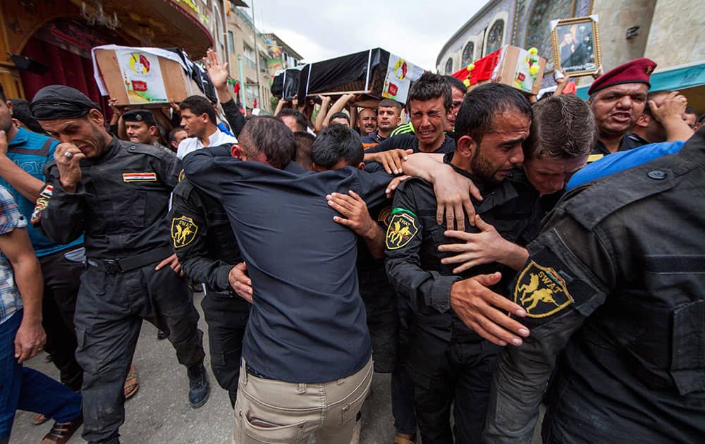 Members of Iraqs Special Weapons and Tactics Team (SWAT) mourn during the funeral procession for their colleagues in the Shiite holy city of Karbala, 50 miles (80 kilometers) south of Baghdad, Iraq.