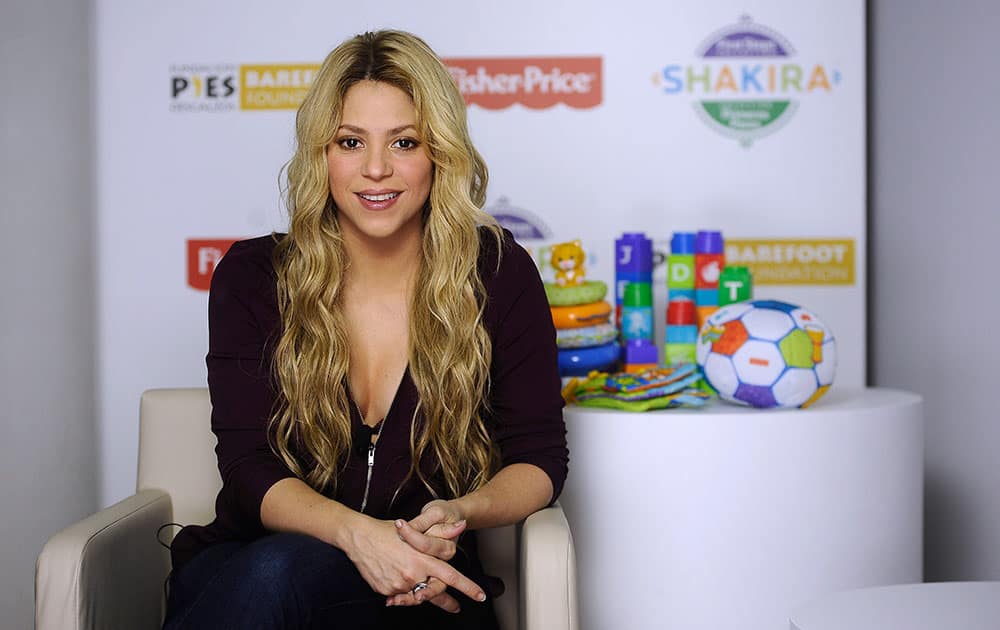 Colombian singer Shakira poses for photographs during an interview with The Associated Press in Barcelona, Spain. Shakira is partnering with a toy maker to launch a collection of baby toys.