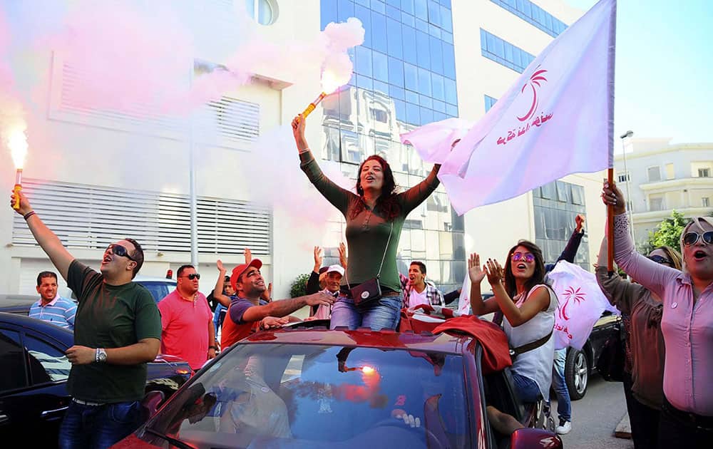 Supporters of Tunisian party Nida Tunis (Tunisia Calls) celebrate their victory in parliamentary elections in Tunis.