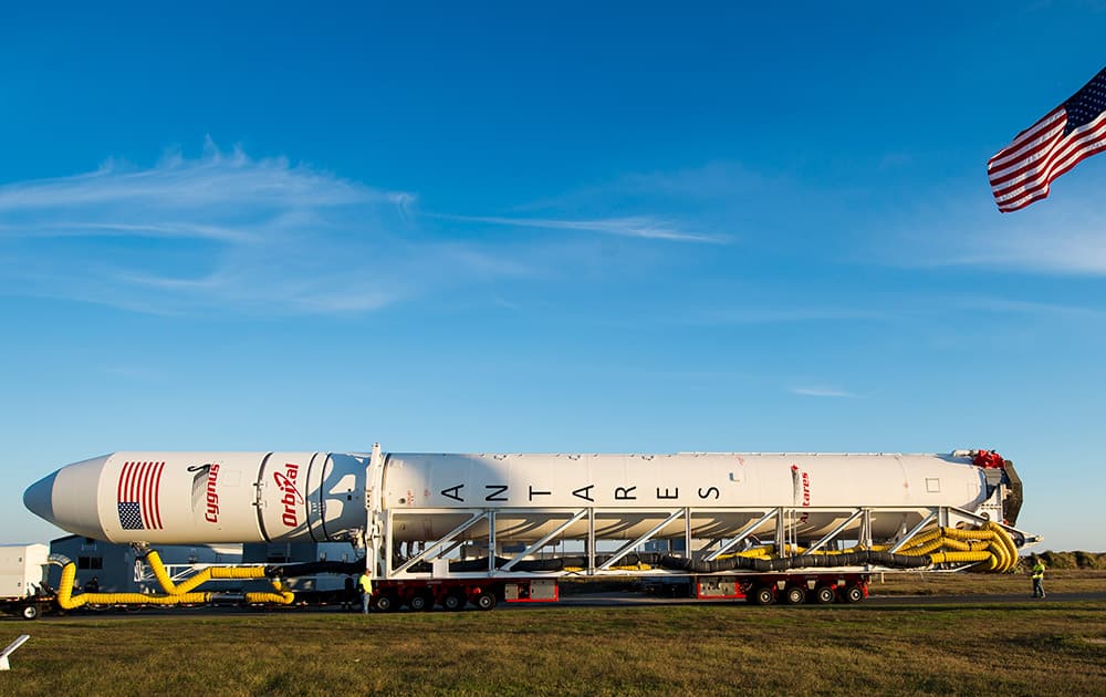 The Orbital Sciences Corporation Antares rocket, with the Cygnus spacecraft onboard, rolls from the Horizontal Integration Facility (HIF) to launch Pad-0A, at NASA's Wallops Flight Facility in Virginia.
