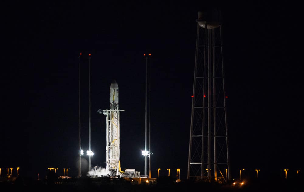 This image provided by NASA shows the Orbital Sciences Corporation Antares rocket, with the Cygnus spacecraft onboard, on launch Pad-0A after the launch attempt was scrubbed because of a boat down range in the trajectory Antares would have flown had it lifted off, at NASA's Wallops Flight Facility in Wallops Island, Va.