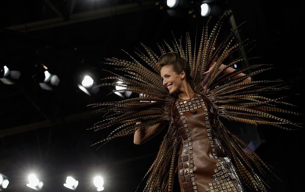 French actress Elodie Varlet presents a dress made out of chocolate, during a show as part of the chocolate fair in Paris.