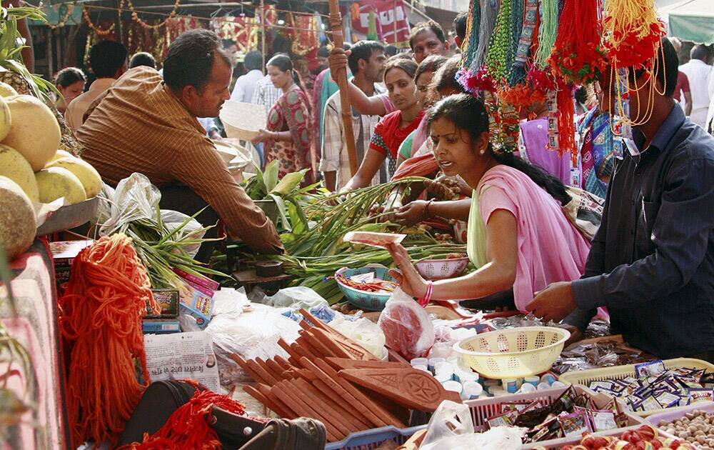 Women purchase vegetables and other things for the Chhath Puja festival in Gurgaon.