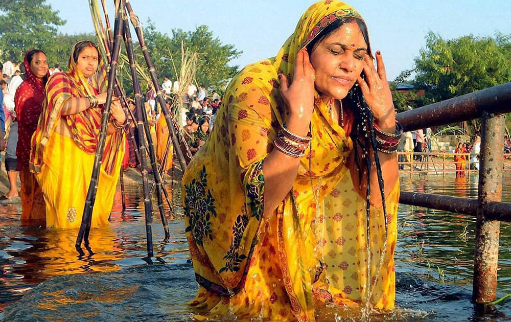 Devotees take holy bath and offer prayers during Chhath festival in Ranchi.