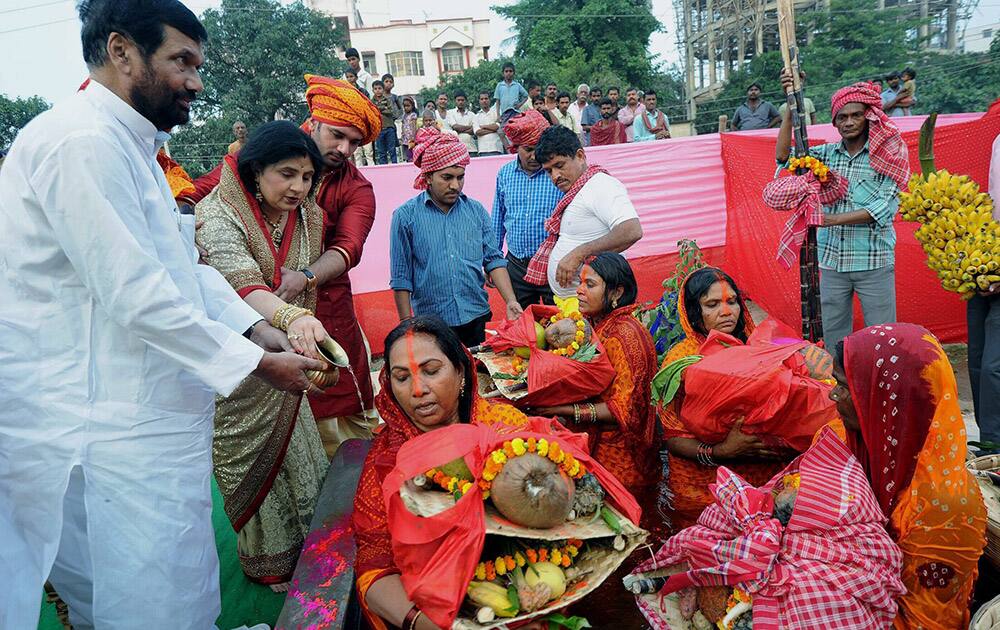 Union minister Ram Vilas Paswan with son & MP Chirag Paswan and family members offer prayers during Chhath festival celebrations in Patna.