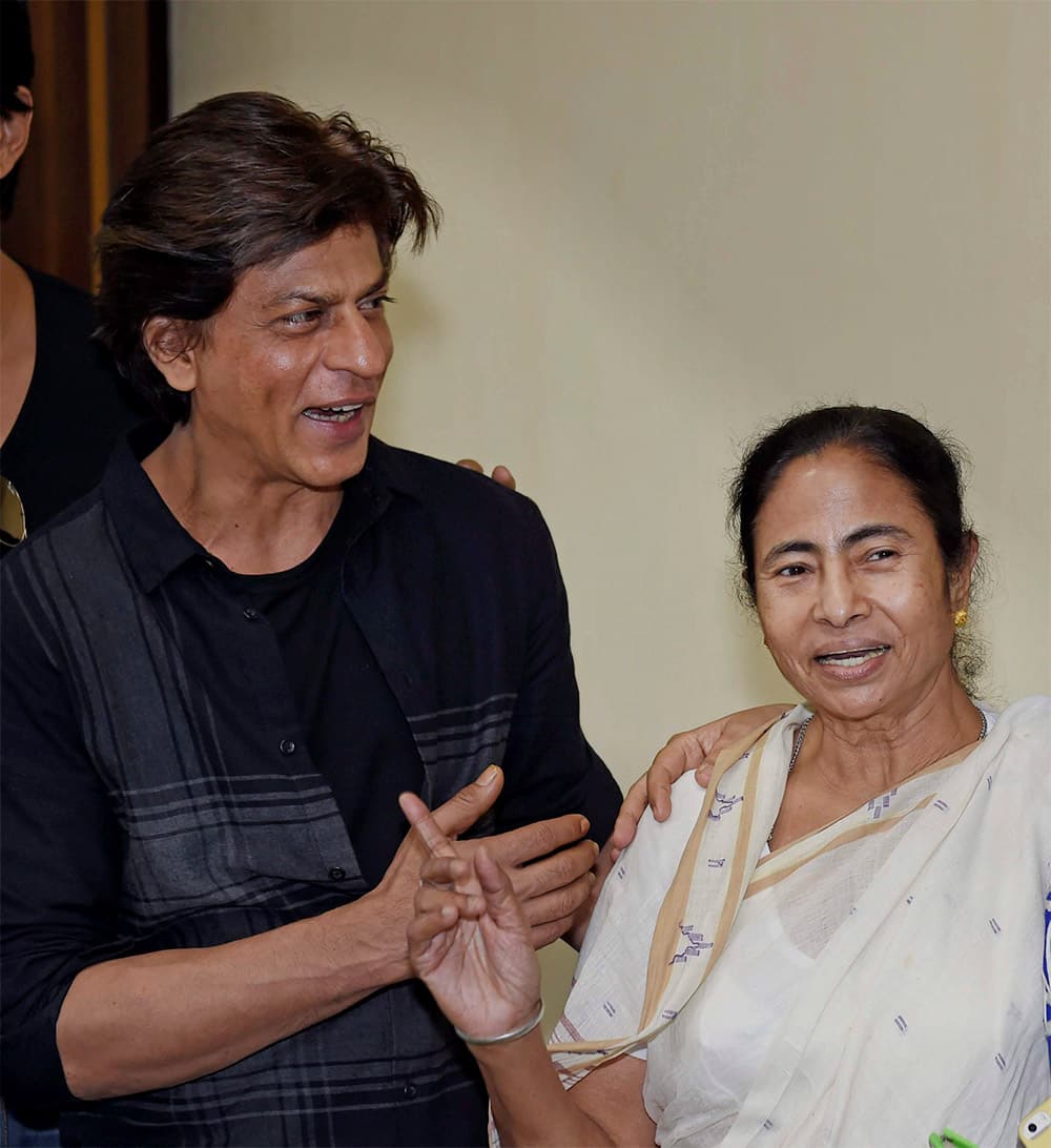 West Bengal Chief Minister Mamata Banerjee with Bollywood actor Shahrukh Khan at a meeting at CM Office in Kolkata. Shahrukh and other star cast of Happy New Year were in Kolkata to promote their film.