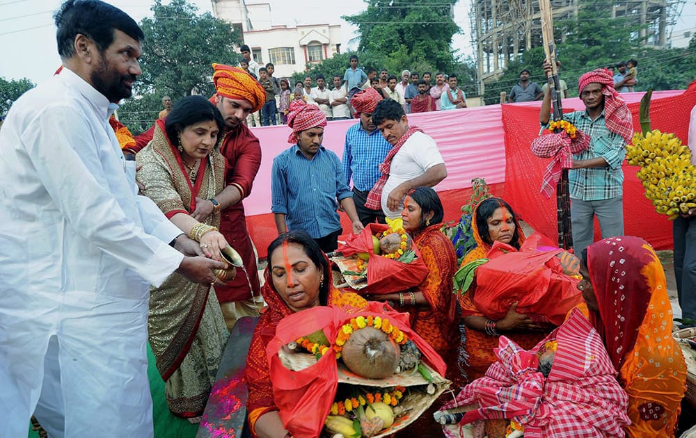 Union minister Ram Vilas Paswan with son & MP Chirag Paswan and family members offer prayers during Chhath festival celebrations in Patna.