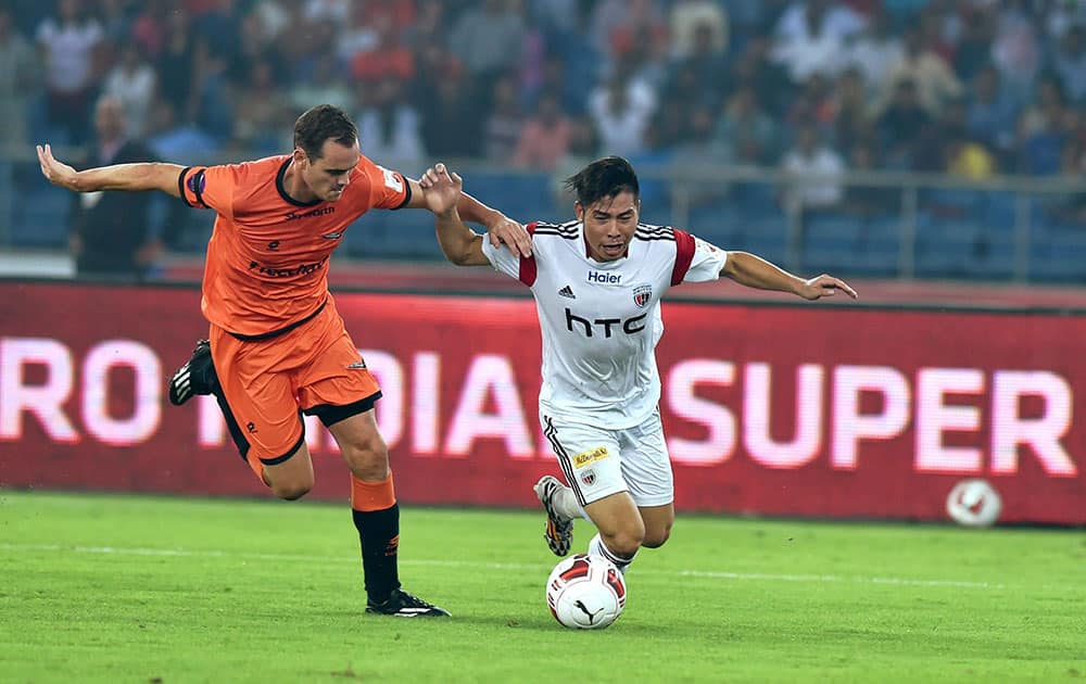 Delhi Dynamos FC player (orange) and NorthEast United FCs Robin Gurung (white) in action during the ISL match at Nehru Stadium in New Delhi.