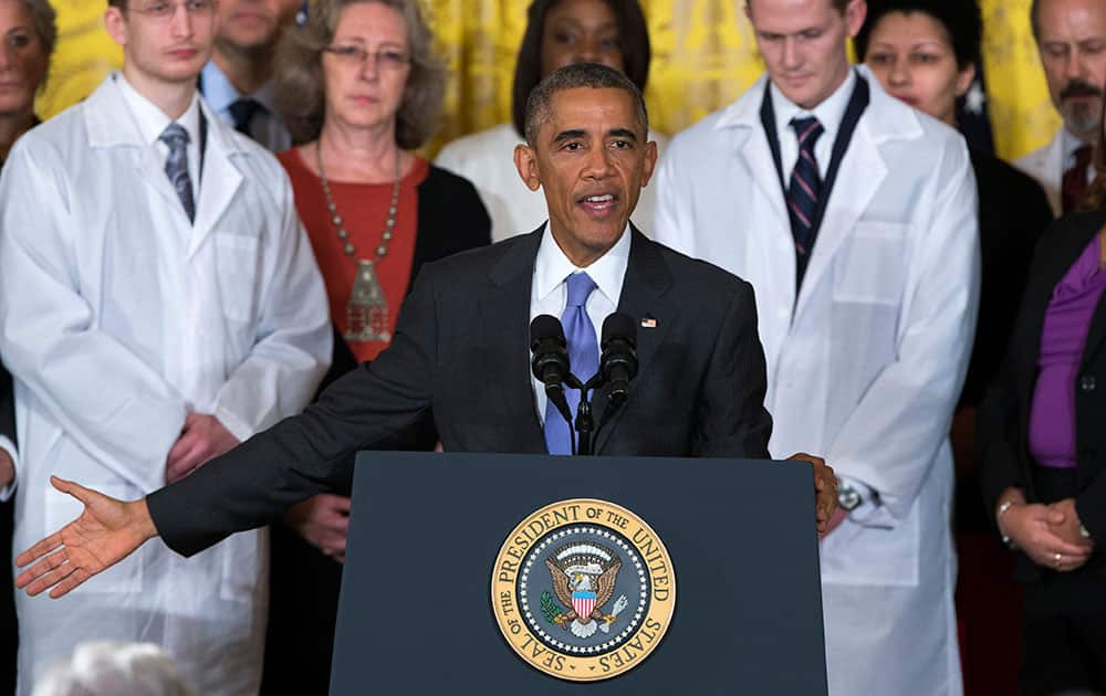 President Barack Obama gestures during remarks at an event with American health care workers fighting the Ebola virus, in the East Room of the White House in Washington.