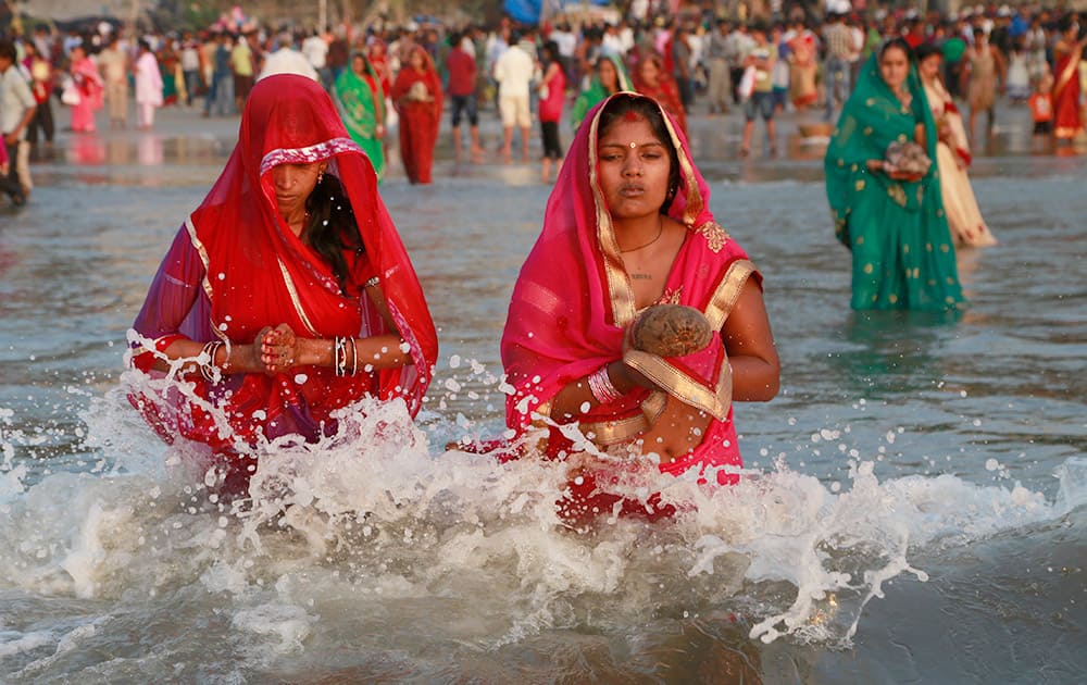 Hindu women offer prayers as the sun sets over the Arabian Sea during Chhath Puja festival in Mumbai. On Chhath, an ancient Hindu festival, rituals are performed to thank the Sun God for sustaining life on earth. 