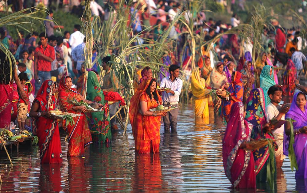 Hindu women perform rituals at sunset to mark Chhath Puja festival in Hyderabad.