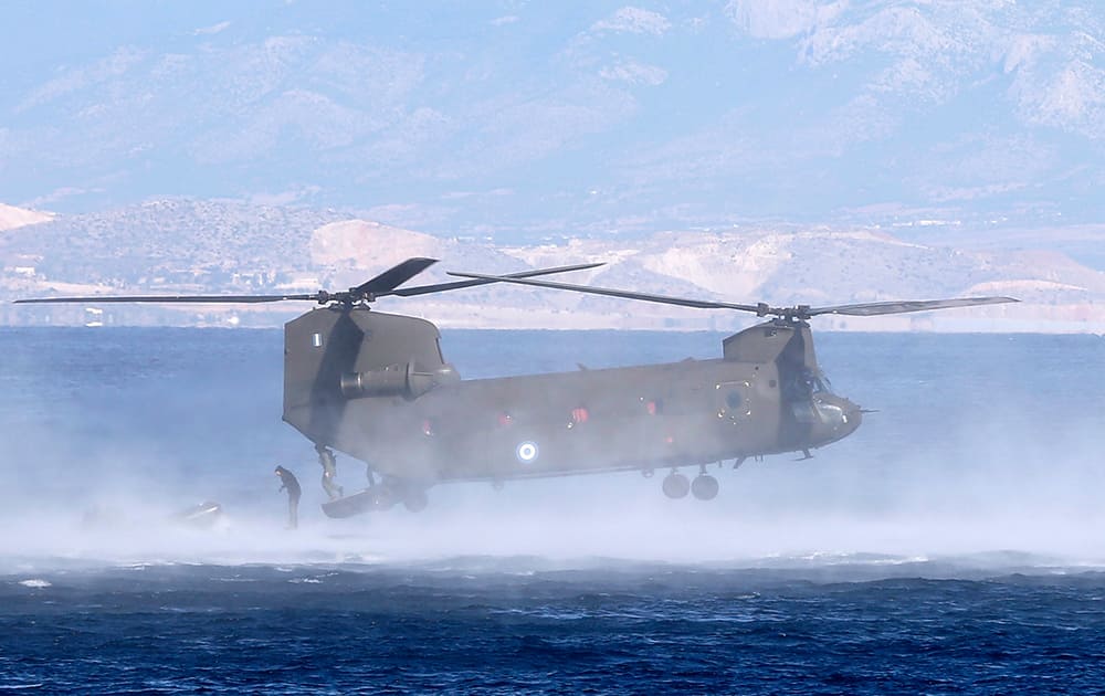 Members of Greek Navy special forces operate from a military helicopter during a Greek joint military exercise 'Pyrpolitis' at the Saronic Gulf, south of Athens.