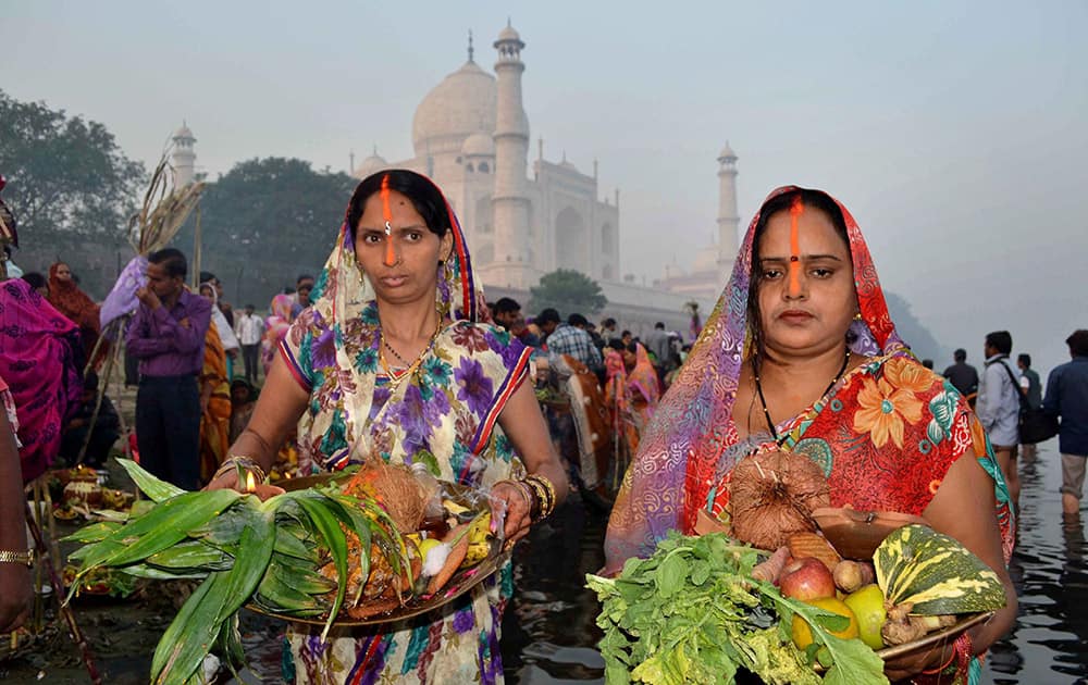 Devotees offer prayer during Chhath puja festival in Agra.