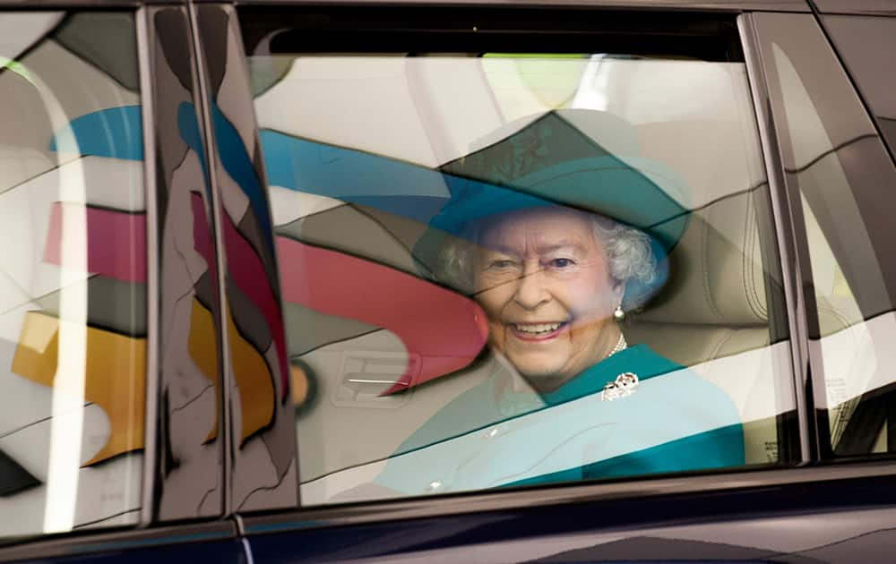 Britain's Queen Elizabeth II leaves following an official visit to International Security Printers to view their work on specialist postage stamps, in Wolverhampton, England.