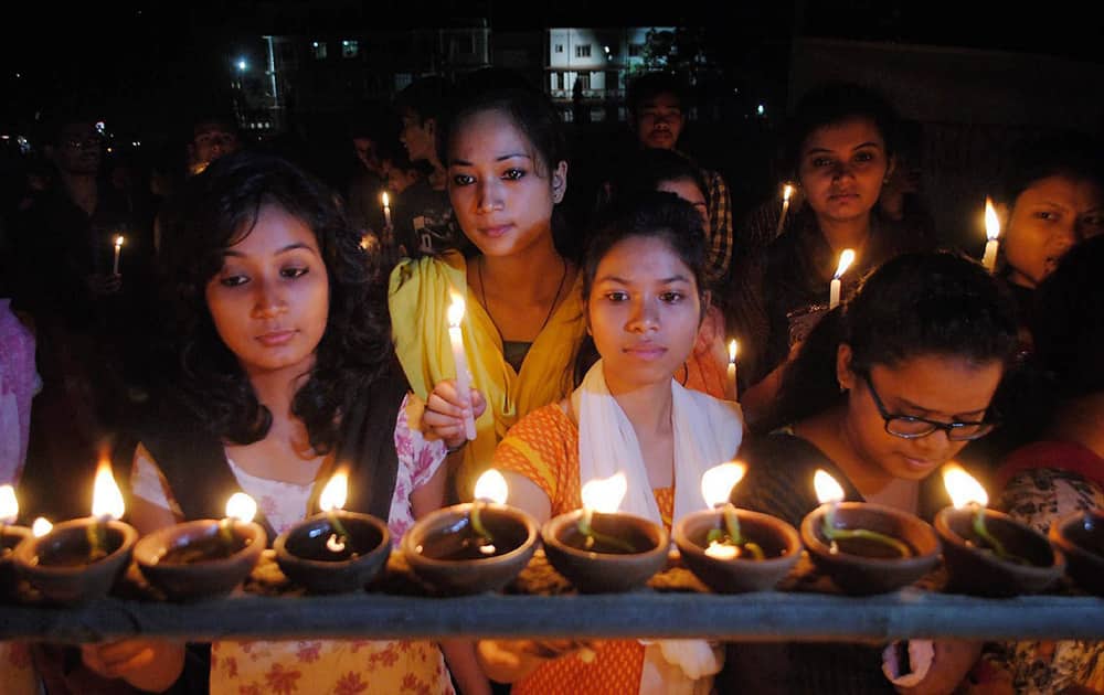 Girls lighting candles and earthen lamps at Latasil play ground in Guwahati on Thursday to commemorate October 30, 2008 serial bomb blasts.