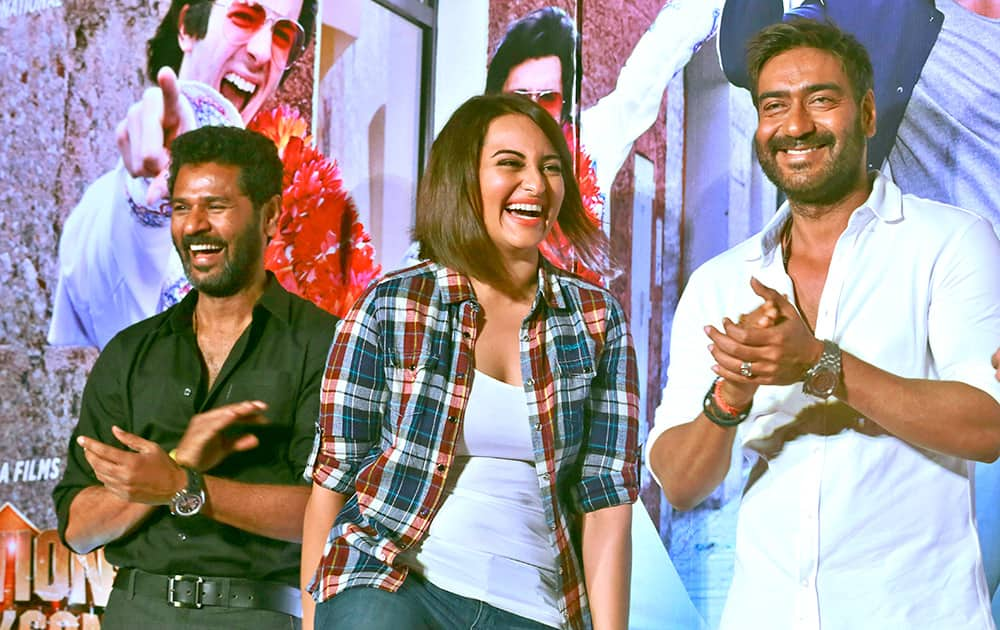 Bollywood Director Prabhu Deva, left, actors Ajay Devgan, right and Sonakshi Sinha share a lighter moment during a song launch of their movie ‘Action Jackson’ in Mumbai.