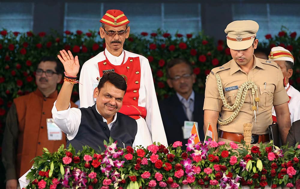 Devendra Fadnavis waves to the crowd after being sworn in as chief minister of Maharashtra state in Mumbai.
