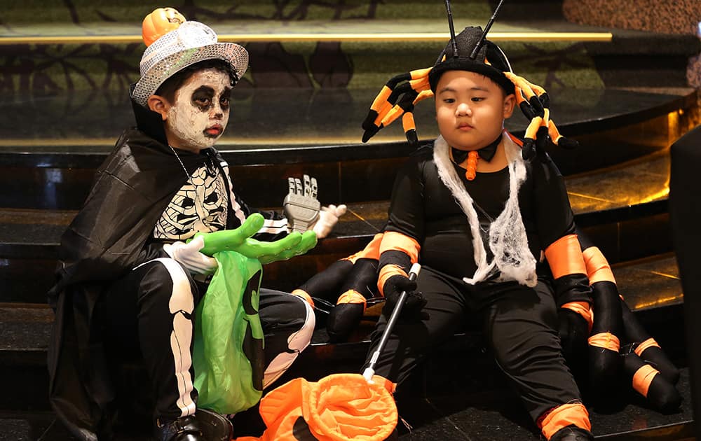 Filipino boys wear costumes along a staircase as they join a Halloween celebration at a hotel in Manila, Philippines.