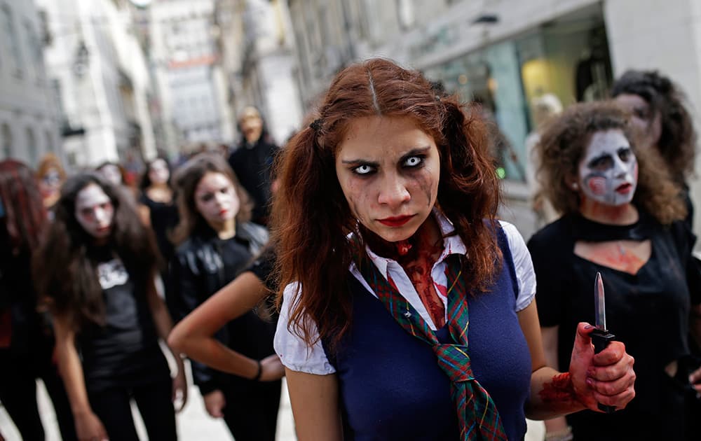 A group of youngsters dressed as ghouls and zombies for Halloween parade in downtown Lisbon.