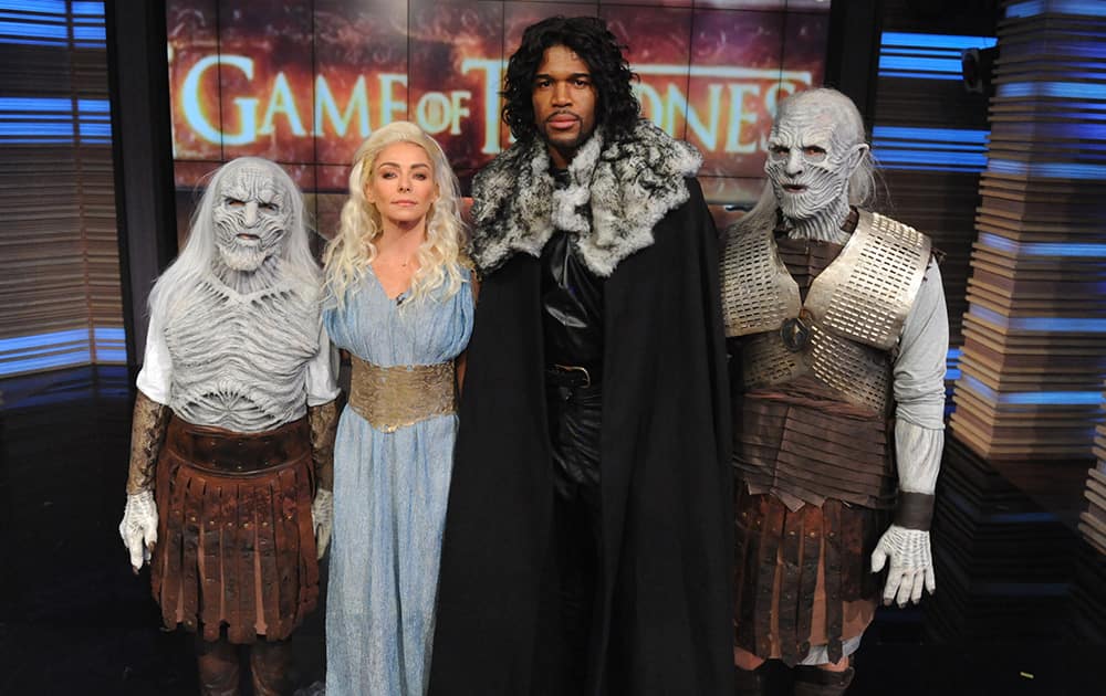 Co-hosts Kelly Ripa, second left, dressed as Daenerys Targaryen and Michael Strahan, dressed as Jon Snow, second right, from the HBO Series 'Game of Thrones,' during the production of the Halloween episode of 'LIVE with Kelly and Michael' in New York.