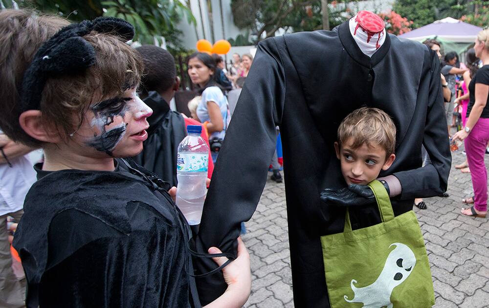 Two young boy's dressed for Halloween prepare to trick-or-treat in a housing compound in South Jakarta district in Jakarta, Indonesia.