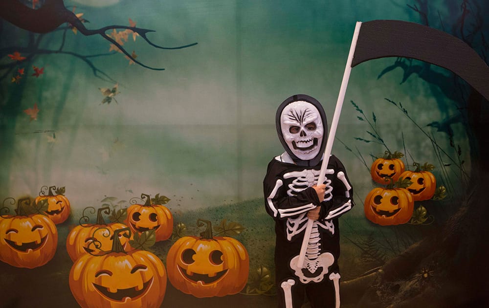 A boy dressed as 'La Muerte' poses for a phot after taking part in a Halloween costume contest at a shopping mall in Managua, Nicaragua.