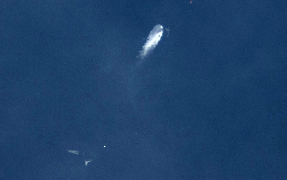 The Virgin Galactic SpaceShipTwo rocket explodes in the air during a test flight. The explosion killed a pilot aboard and seriously injured another while scattering wreckage in Southern California's Mojave Desert, witnesses and officials said.