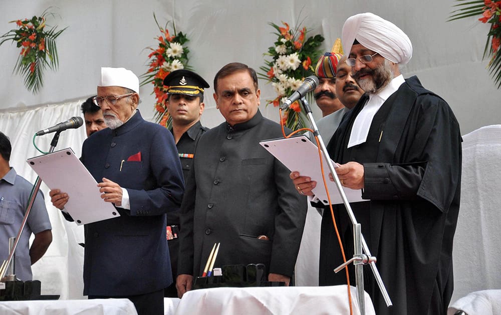 Jharkhand Governor Syed Ahmed administers oath to the new Chief Justice of Jharkhand High Court, Virendra Singh at Raj Bhawan in Ranchi.