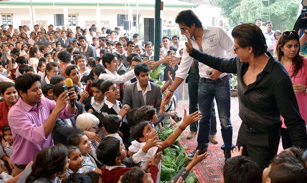 Actors Shahrukh Khan and Sonu Sood celebrating the success of thier film Happy New Year at a school in Jaipur.