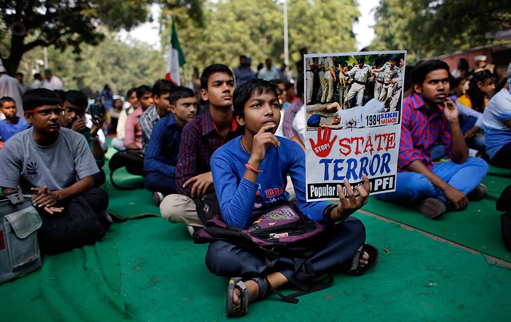 A young Indian holds a placard during a protest demanding justice for victims of the 1984 massacre of Sikhs following the assassination of Indira Gandhi, the then Prime Minister of India, and other instances of communal violence, in New Delhi.