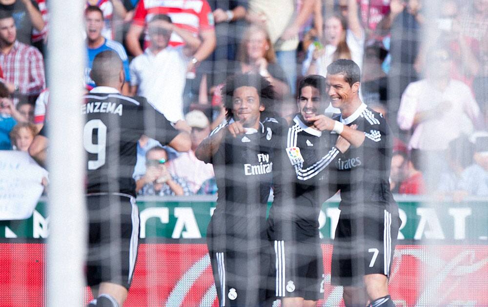 Real Madrids Cristiano Ronaldo, right, celebrates his goal with teammates during a Spanish La Liga soccer match between Granada and Real Madrid at the Nuevo Los Carmenes stadium in Granada, Spain .