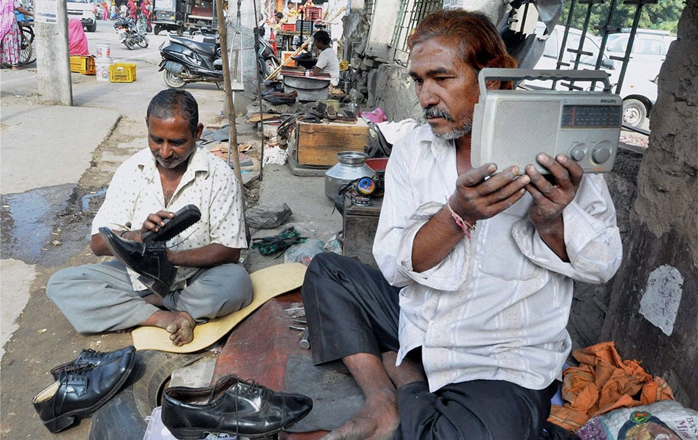 People listening to Mann ki Baat addressed by Prime Minister Narendra Modi, on a radio at Beawar.