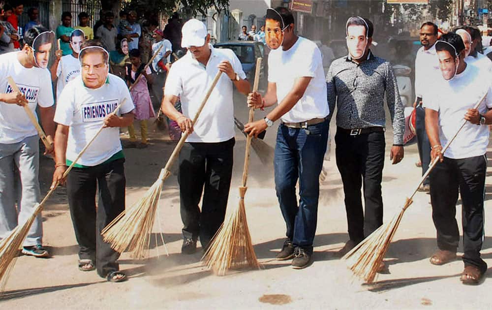 Members of Friends Club wearing masks of celebrities in a cleanliness drive during `swachh bharat abhiyan` in Guwahati.